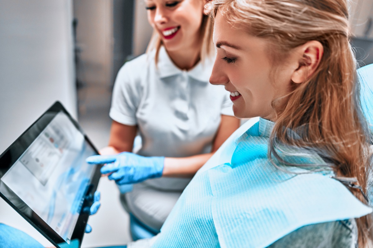 denture patient looking at tablet for assessing their digital dentures