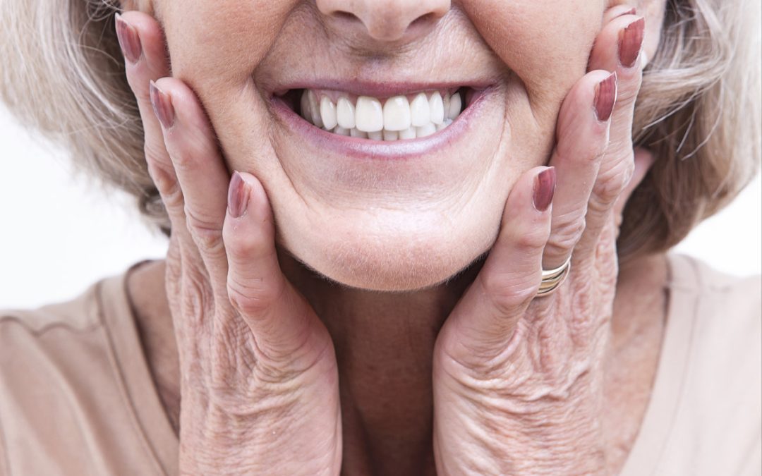 woman smiling with new set of dentures